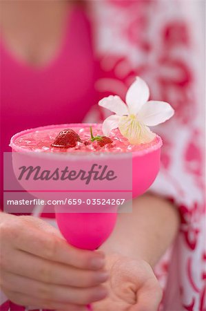 Woman holding summery strawberry drink