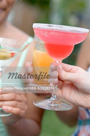 Women with different drinks out of doors Women with different drinks out of doors