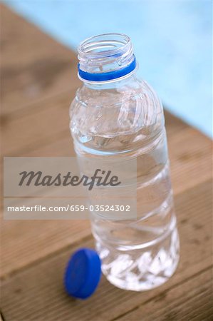 Bottle of water by swimming pool