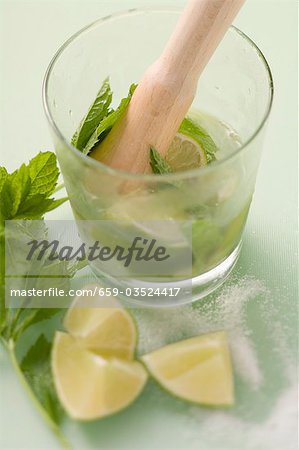 Making Mojito with lime and mint