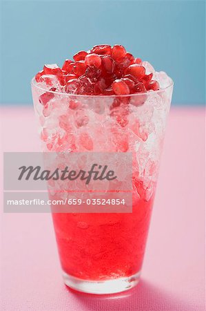 Glass of pomegranate juice with crushed ice & pomegranate seeds