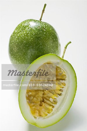 Green passion fruits, whole and half