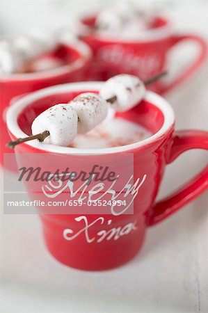 Marshmallows on sticks on cups of cocoa (Christmas)
