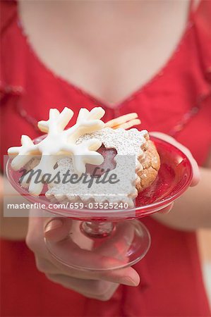 Woman holding dish of Christmas biscuits