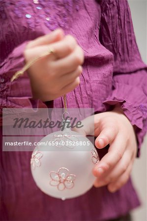 Child holding Christmas bauble