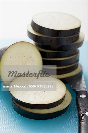 Aubergine slices on chopping board