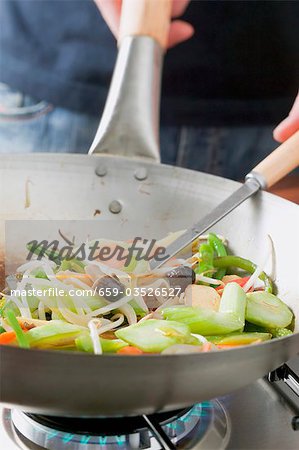 Frying Asian vegetables in frying pan