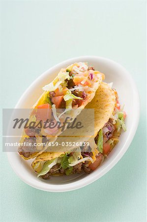 Two mince tacos in white dish