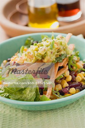 Lettuce, beans, sweetcorn, tortilla strips and guacamole