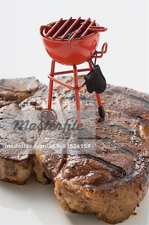 Grilled T-bone steak with toy barbecue