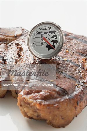 Grilled T-bone steak with meat thermometer Grilled T-bone steak with meat thermometer