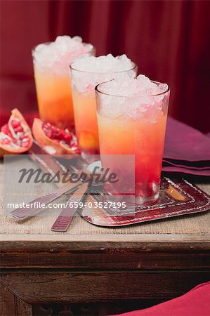 Three fruity drinks with orange and pomegranate Three fruity drinks with orange and pomegranate