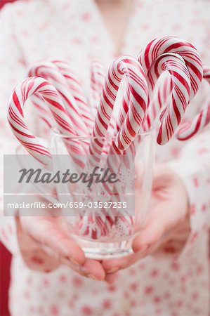 Woman holding glass of candy canes