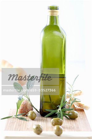 Bottle of olive oil, herbs, olives and white bread