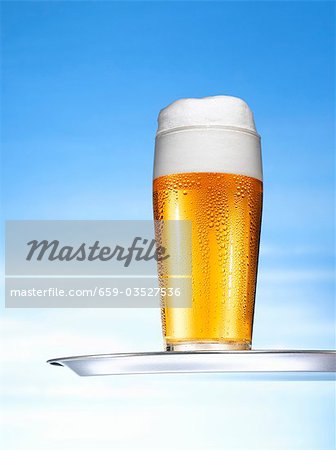 Glass of lager on tray Glass of lager on tray