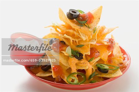 Nachos with cheese, olives, chilli rings, ketchup & sour cream