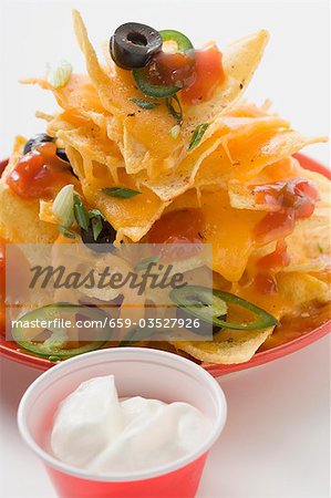 Nachos with cheese, olives, chilli rings, ketchup & sour cream