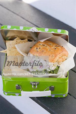 Chicken sandwich and crisps in lunch box