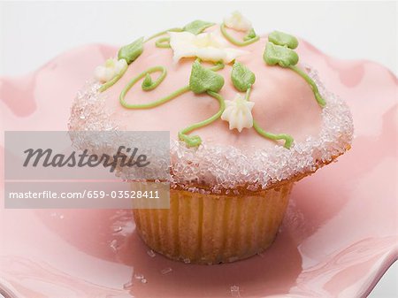 Petit gâteau avec des fleurs roses de givrage et de la crème au beurre