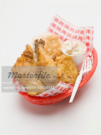 Fried chicken with coleslaw and scone in plastic basket