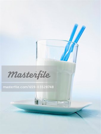 Glass of milk with two straws