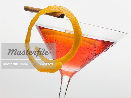 Cosmopolitan with lemon and cinnamon stick Cosmopolitan with lemon and cinnamon stick
