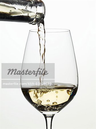 Pouring white wine into a glass