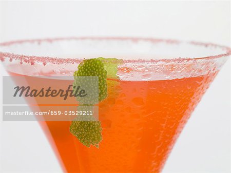 Strawberry drink in glass with sugared rim and lime peel Strawberry drink in glass with sugared rim and lime peel