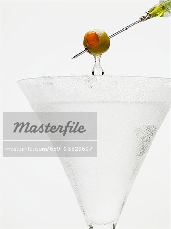 Martini with olive on cocktail stick