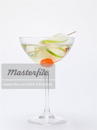 Drink with cocktail cherry and lime Drink with cocktail cherry and lime