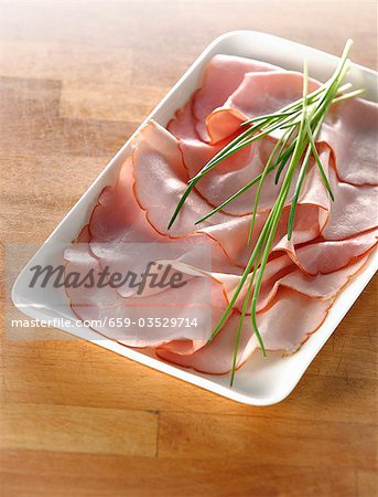 Several slices of boiled ham and fresh chives