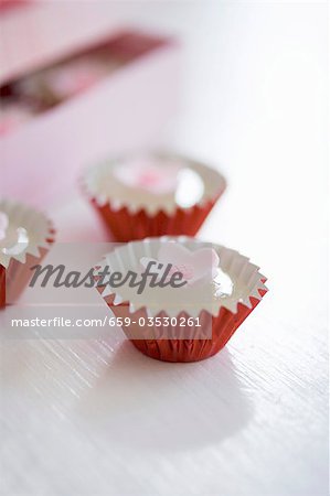 Small Candies with Flowers in Petit Four Cases
