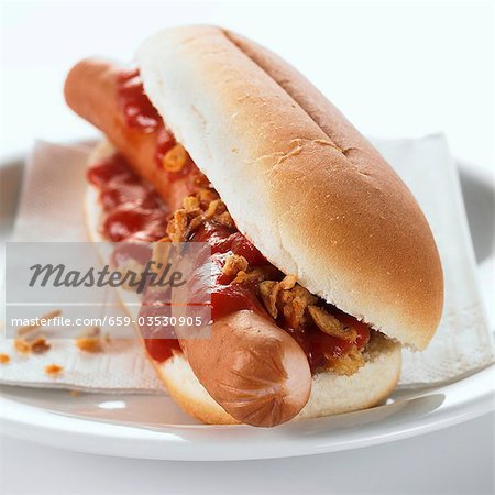 Hot dog with ketchup on plate