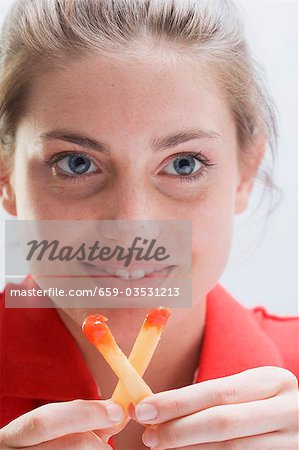 Smiling woman holding two chips