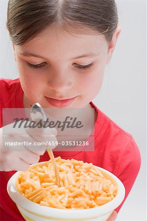 Little girl eating pasta