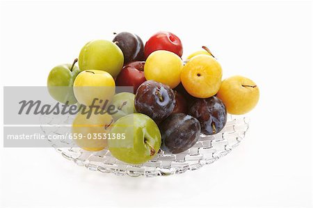 Red and yellow plums, damsons, greengages on plate