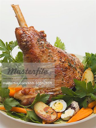 Lamb shank with quails' eggs, carrots and parsley for Easter