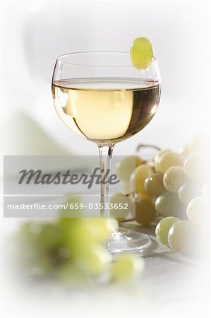 Grape juice in glass, green grapes