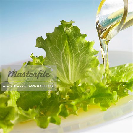 Oil running onto lettuce leaves