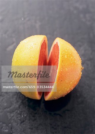 A pink grapefruit, cut in half