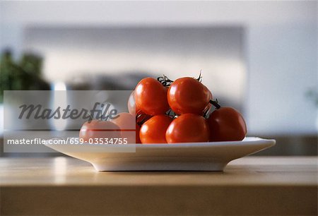 Tomatoes in dish on kitchen table