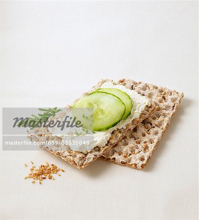 Sesame crispbread with soft cheese, cucumber and chives