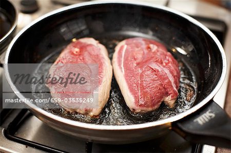 Frying duck breast, skin-side down