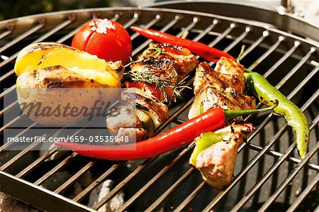 Brochettes de porc et les légumes sur la grille du barbecue