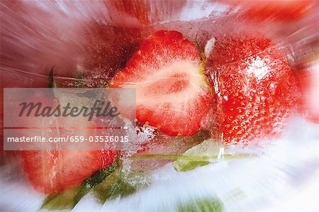 Strawberries in block of ice (close-up)