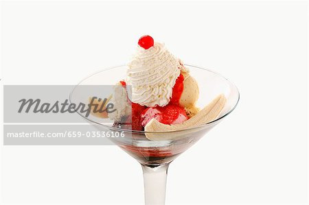 Banana split with strawberry sauce and whipped cream