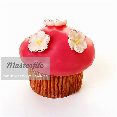 Muffin with pink icing and sugar flowers
