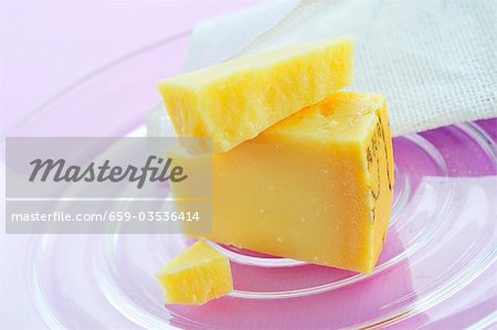 Pieces of Parmesan on glass plate