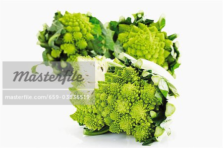 Romanesco broccoli, two whole and one halved