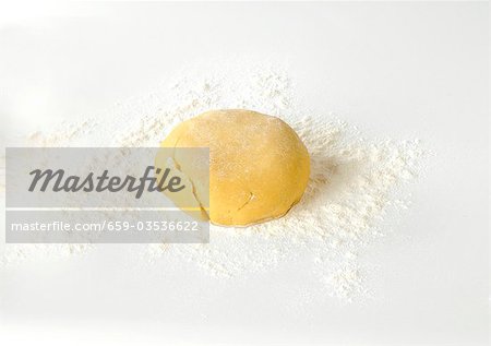 Shortcrust pastry dough on floured surface